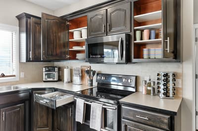 Your fully equipped kitchen features sleek dark cabinetry, stainless steel appliances, and everything you need to create memorable meals during your stay.