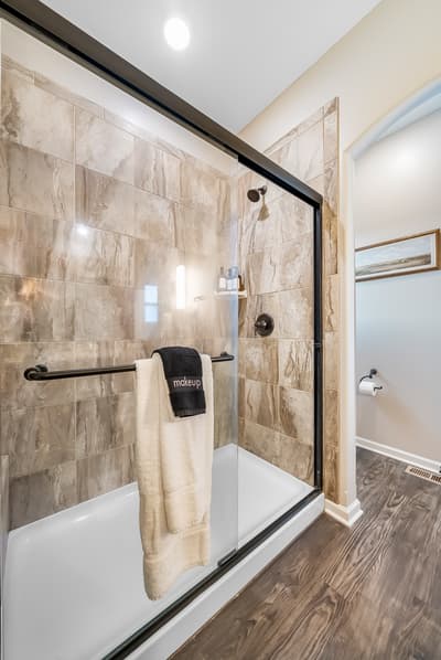 Step into your luxurious bathroom with marble-look tiles and spacious glass shower - fresh towels await your arrival.