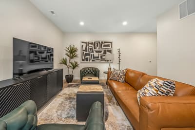 Sink into plush leather seating while enjoying your favorite shows on the large flat-screen TV in this stylish lounge space.