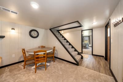 Your cozy lower level features a charming dining nook and carpeted living space, perfect for quiet meals or relaxing evenings together.