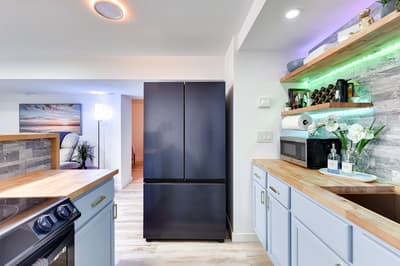 Your modern kitchen awaits with sleek appliances, warm wood countertops, and ambient LED lighting creating the perfect culinary retreat.