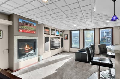 Settle into your personal entertainment haven with a crackling fireplace and multiple screens for endless viewing options.