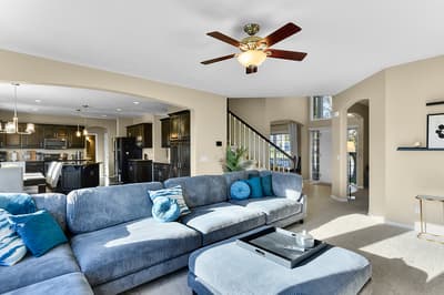 Sink into plush sectional seating in your spacious living room, where natural light flows through tall windows and an open layout connects to your fully-equipped kitchen.