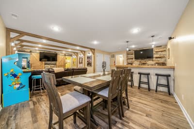 Your private entertainment haven awaits with rustic beams, cozy seating, and a fully equipped bar for memorable gatherings.