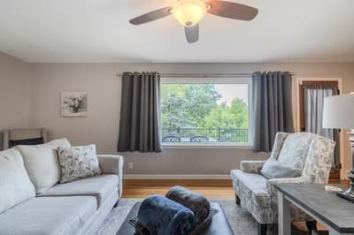 Relax in your bright living room with comfortable seating and peaceful garden views through the large window.