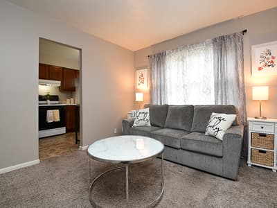 Settle into this cozy living room where soft natural light, plush seating, and warm touches invite you to unwind after exploring the area.