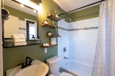 Unwind in your stylishly renovated bathroom with spa-like touches, wooden shelving, and a relaxing soaking tub.