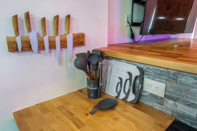 Your gourmet kitchen features professional-grade knives, quality cookware, and warm wood countertops—everything you need to create memorable meals.