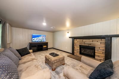 Sink into plush seating by your cozy stone fireplace while enjoying your favorite shows on the large screen TV.