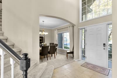 Step into your welcoming foyer where elegant archways frame the dining space, perfect for memorable meals together.