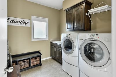 Your dedicated laundry room makes staying fresh effortless with full-size washer and dryer, beautiful cabinetry, and thoughtful storage solutions.