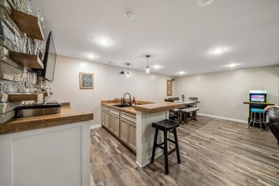Your spacious basement retreat features a fully equipped kitchen, cozy dining area, and entertainment zone perfect for memorable gatherings.