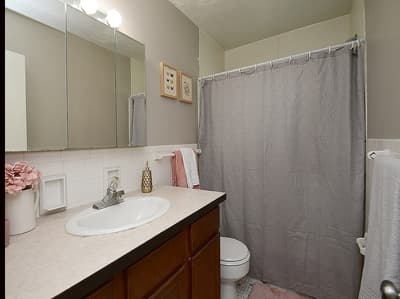 Your private bathroom features thoughtful amenities with a convenient shower-tub combo, classic tile detailing, and soft towels ready for your arrival.