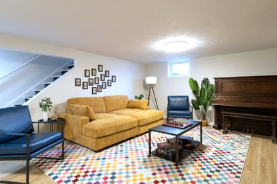 Unwind in your cozy living space with plush seating, vibrant decor, and a welcoming fireplace for perfect evening relaxation.
