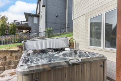 Soak your stress away in your private hot tub while enjoying peaceful neighborhood views from this inviting outdoor retreat.