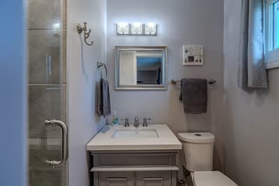 Step into your pristine bathroom featuring modern fixtures, fresh towels, and a spacious glass shower—your personal sanctuary awaits.
