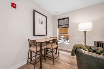 Enjoy intimate meals at your stylish dining table, where warm lighting and modern comfort create the perfect setting for memorable conversations.