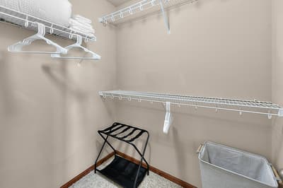Your spacious walk-in closet features plenty of hanging space, shelving for linens, and a convenient luggage stand for easy unpacking.