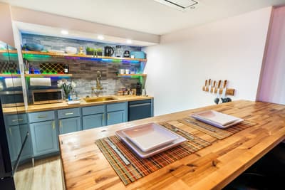 Your stylish kitchen features warm wood countertops, modern blue cabinets, and everything you need to create delicious meals during your stay.