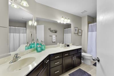 Your spa-like bathroom features dual vanities, elegant fixtures, and refreshing amenities to start your mornings perfectly.