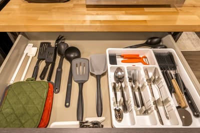 Your kitchen drawer is perfectly organized with everything you need—from cooking utensils to silverware—all neatly arranged for effortless meal preparation.