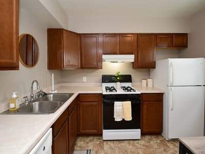 Your fully equipped kitchen features warm wood cabinetry, modern appliances, and everything you need to prepare home-cooked meals during your stay.