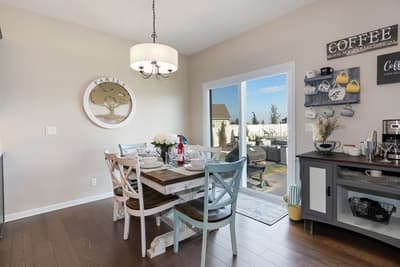 Gather around your welcoming dining table for memorable meals, with coffee station ready and patio doors opening to your private outdoor space.