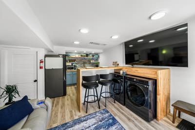 Your modern basement retreat combines relaxation with convenience—featuring a full kitchen, laundry, and cozy living space perfect for extended stays.