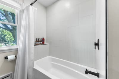 Step into your serene spa-like retreat with a luxurious soaking tub, rainfall shower, and peaceful garden views through your window.