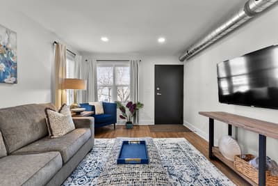 Sink into plush seating while streaming your favorites on the large TV in this thoughtfully designed living space with modern touches.