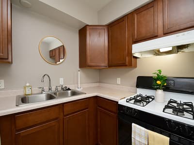 Your well-appointed kitchen features warm wood cabinetry, a gas stove for home-cooked meals, and plenty of counter space to spread out while you prepare your favorite dishes.
