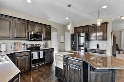 Your gourmet kitchen awaits with granite counters, stainless appliances, and spacious island perfect for cooking together.
