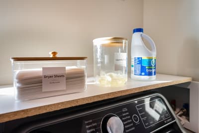 Your laundry is effortless with organized supplies and a modern washer ready for your convenience.