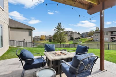 Gather around your private fire table under twinkling lights while enjoying peaceful views of the manicured backyard and neighborhood beyond.