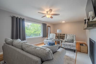 Unwind in your comfortable living room with plush seating, warm lighting, and a cozy fireplace for perfect relaxation.