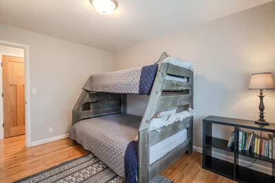Your kids will love this cozy bunk bed space with books nearby for bedtime stories and warm lighting.