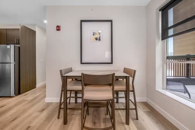 Gather around your stylish dining table for meals and conversations, with natural light streaming through the window.