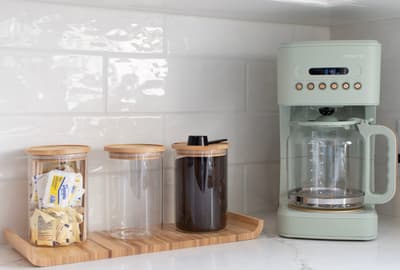 Your mornings start perfectly with this sleek coffee setup, complete with fresh beans and brewing essentials at your fingertips.