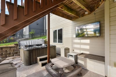 Unwind in your private hot tub while enjoying outdoor entertainment on the mounted TV, all under a beautiful covered pergola.