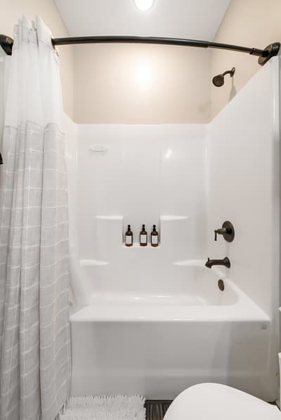 Step into your private spa retreat with this pristine tub-shower combo, complete with luxurious bath amenities and thoughtful touches for ultimate relaxation.