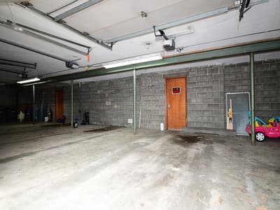 The property includes a secure garage with ample space for vehicle storage and additional equipment, accessible via an automated door opener.
