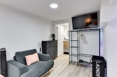 Relax in your modern studio with plush seating, smart TV, and thoughtful touches like open wardrobe storage for extended stays.