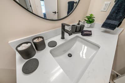 Step into your stylish bathroom featuring a sleek vanity with thoughtful amenities and fresh touches that make your morning routine feel luxurious.