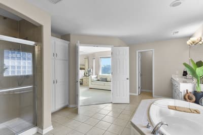 Unwind in your spacious master bathroom with a soaking tub, separate shower, and direct views into your cozy bedroom retreat.