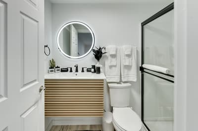 Your stylish bathroom features a modern vanity, LED mirror, and glass shower—perfect for refreshing morning routines.