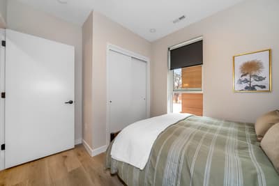 Drift off peacefully in your cozy bedroom with soft linens and cheerful natural light streaming through your window.