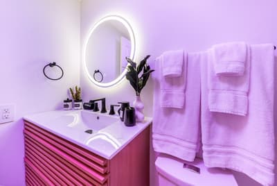 Pamper yourself in this spa-inspired bathroom with LED lighting, sleek fixtures, and plush towels for your daily refresh.