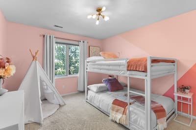 Your children will love this magical bedroom with fun bunk beds, a play teepee, and soft pink walls for endless adventures.