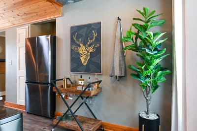 Your stylish kitchen corner features modern appliances and a charming bar cart for evening beverages.