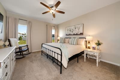 Relax in your peaceful bedroom with cozy farmhouse charm, soft linens, and a gentle ceiling fan for perfect comfort.